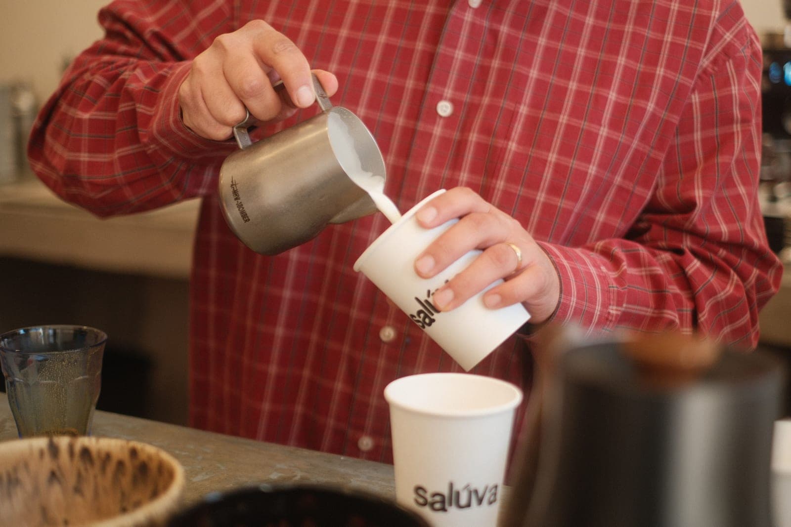 Steamed milk being poured into an espresso to make latte art
